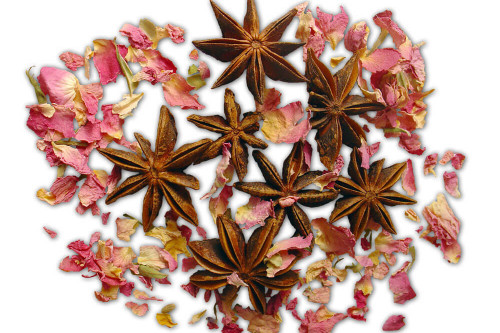 Steenbergs organic star anise alongside Steenbergs organic rose petals.